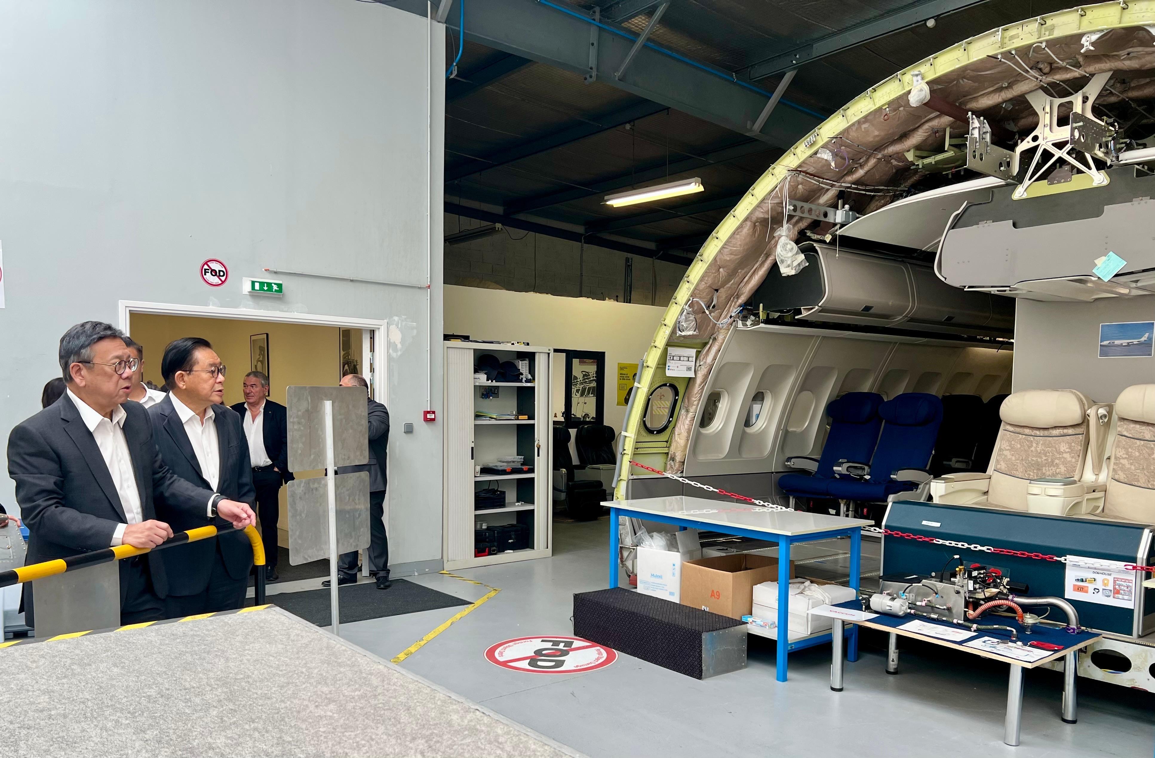 The Secretary for Commerce and Economic Development, Mr Algernon Yau, began his visit to France on June 18 (France time) to promote Hong Kong's unique advantages and vast opportunities for businesses. Photo shows Mr Yau (first left) visiting the Derichebourg Aeronautics Training Center in Toulouse on June 19 (France time) to learn about the latest advancements in related aeronautic training. Looking on are Legislative Council Member Mr Jeffery Lam (second left) and the Group Chairman and Chief Executive Officer of Elior Group SA, Mr Daniel Derichebourg (third left).