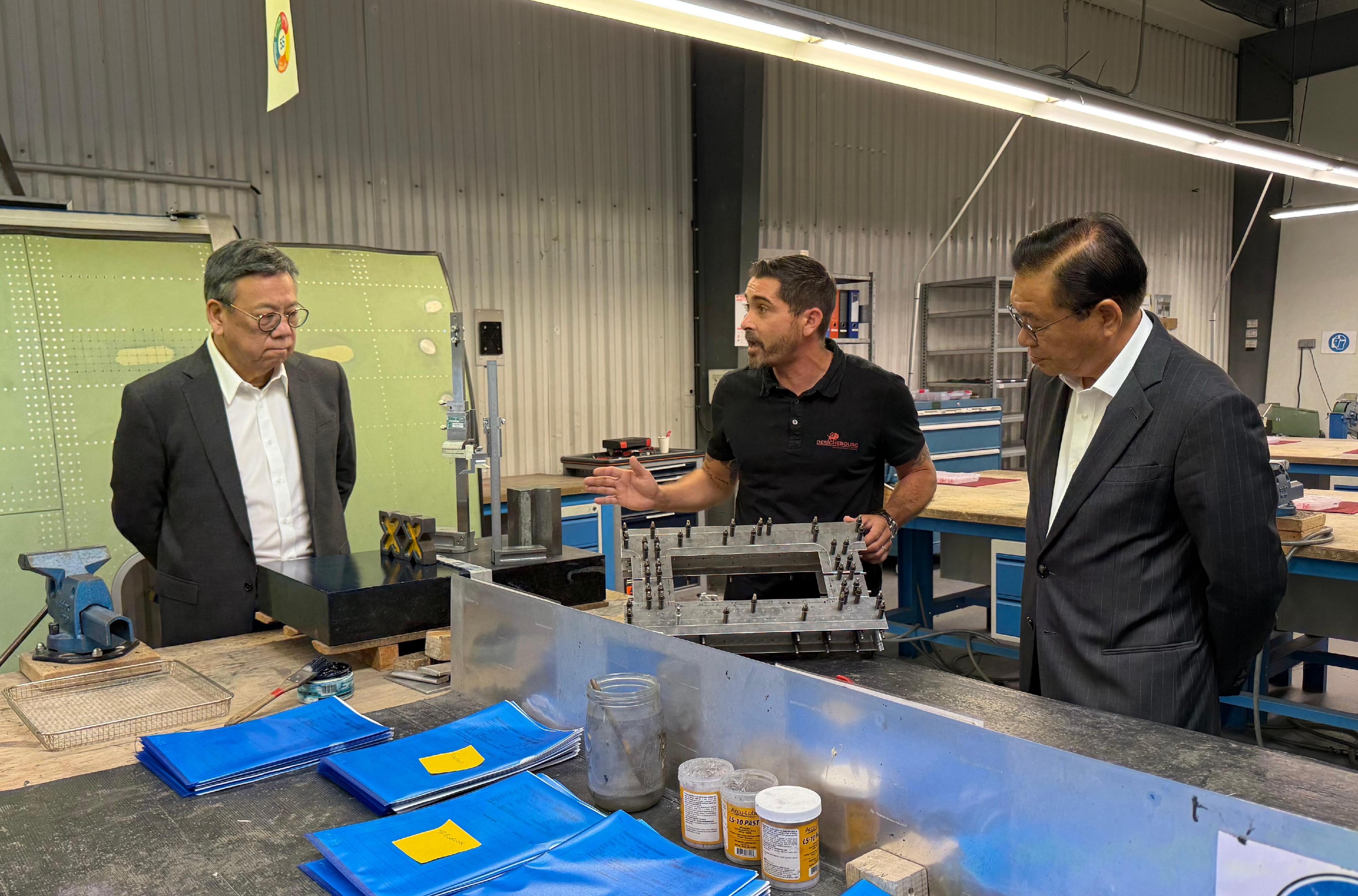 The Secretary for Commerce and Economic Development, Mr Algernon Yau, began his visit to France on June 18 (France time) to promote Hong Kong's unique advantages and vast opportunities for businesses. Photo shows Mr Yau (left) visiting the Derichebourg Aeronautics Training Center in Toulouse on June 19 (France time) to learn about the latest advancements in related aeronautic training. Looking on is Legislative Council Member Mr Jeffery Lam (right).
