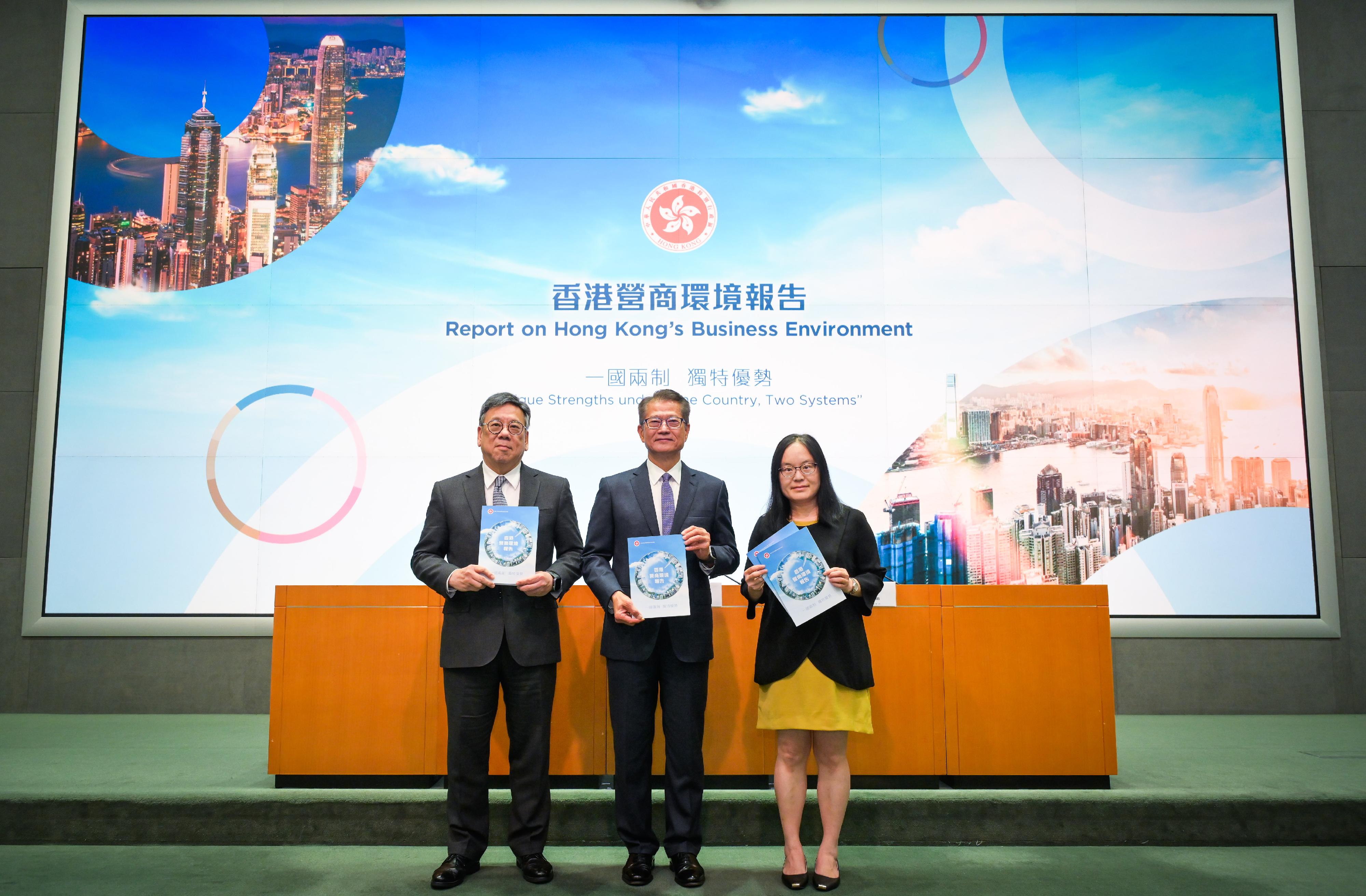 The Financial Secretary, Mr Paul Chan (centre), accompanied by the Secretary for Commerce and Economic Development, Mr Algernon Yau (left), and the Acting Government Economist, Dr Cecilia Lam (right), meets the media today (July 30) on the release of the "Report on Hong Kong's Business Environment: Unique Strengths under 'One Country, Two Systems'"